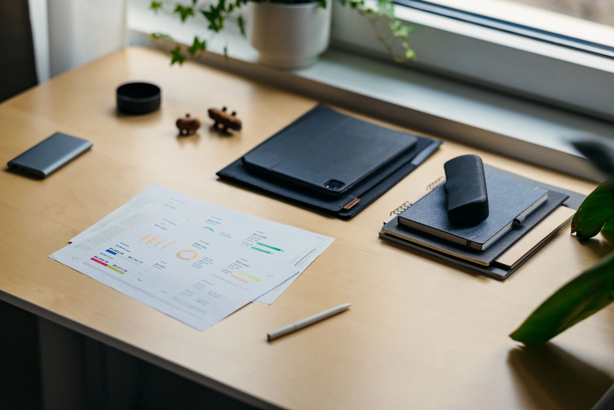 Papers and notebook on an office desk